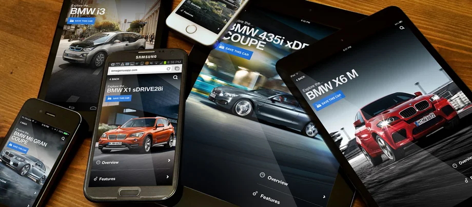 A pile of phones and tablets on a table with the Genius app displayed