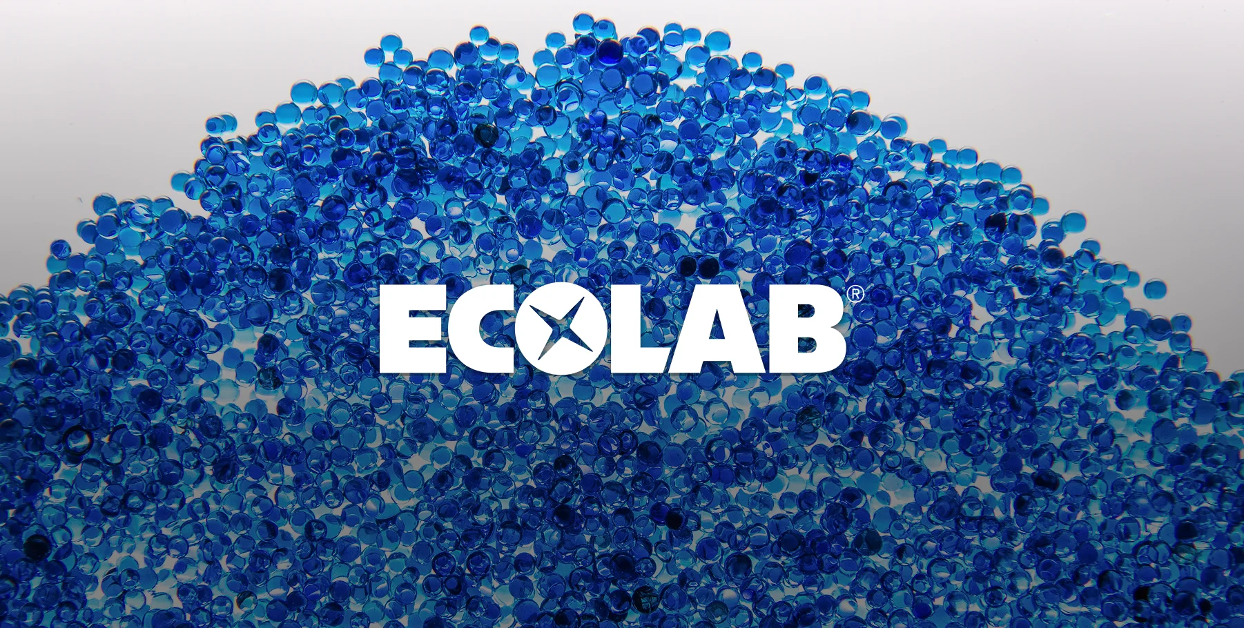 Blue resin beads sitting on a white background